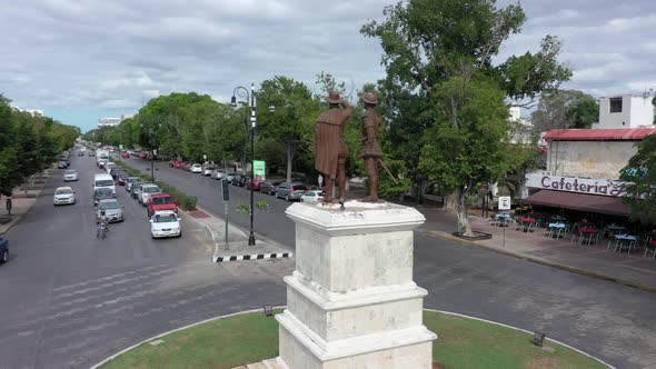 Aerial orbit around the traffic roundabout and monument to Francisco de Montejo and his son, the fou
