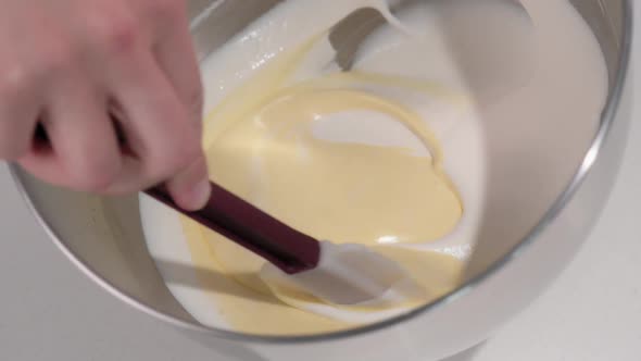 Pastry Chef Kneads the White Mousse for the Cake