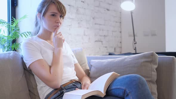 Penisve Woman Reading Book While Sitting on Sofa