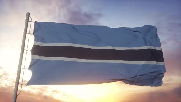 Flag of Botswana Waving in the Wind Sky and Sun Background