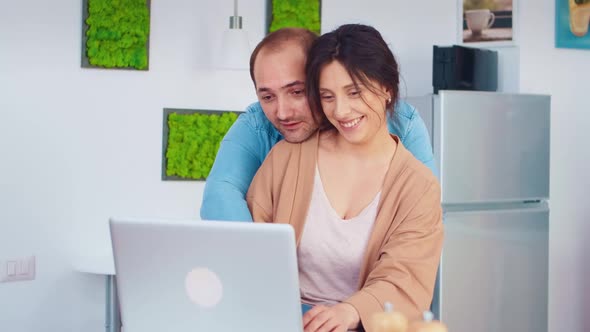 Cheerful Couple Using Laptop