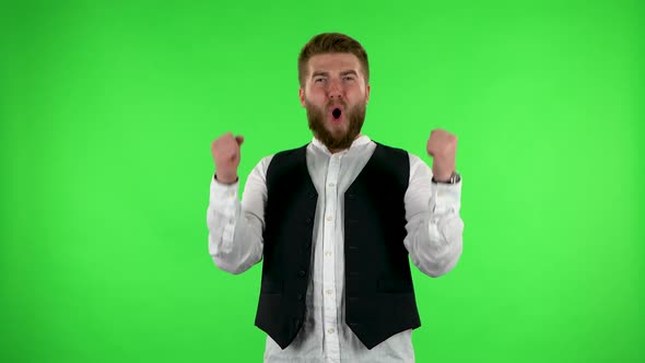 Male Looking at the Camera, Then Celebrating His Victory Triumph on Green Screen.