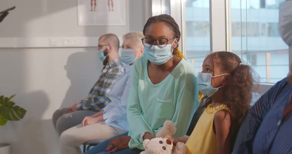 African Doctor Inviting Patients in Hospital Waitingroom for Coronavirus Vaccination