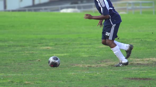 A man playing soccer on a grassy field