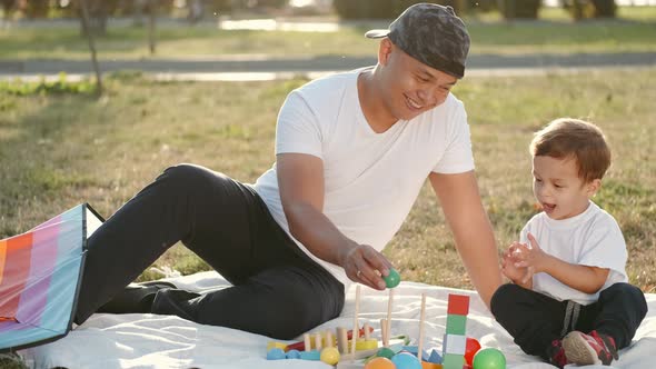 Thai Father Iand Son Are Playing Educational Games in the Park