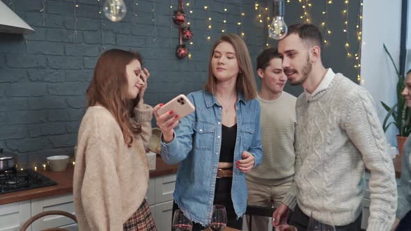 A Team of Happy Young People Pose Together for a Selfie Group Photo Near the Holiday Table