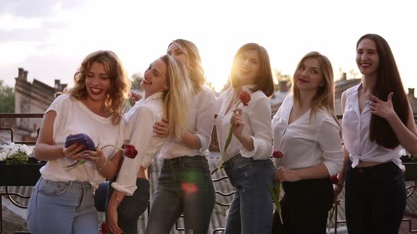 Beautiful Glamour Women in Jeans and White Shirts on a Terrace