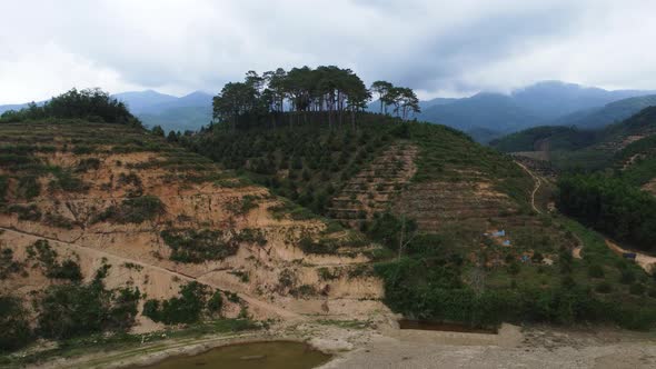 Aerial circling backwards over deforestation site in South Vietnam