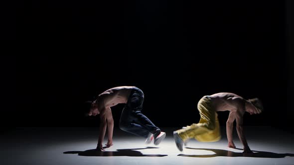 Two Breakdance Dancers with Naked Torso Starts Dance, on Black, Shadow