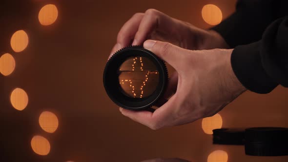 Hand model opens and closes aperture on a cine lens.