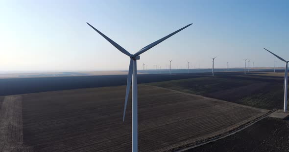 Aerial View Of Wind Turbines On Vast Field. close up, orbiting shot