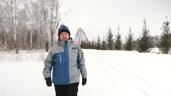 Mature Woman Is Walking In A Winter Day