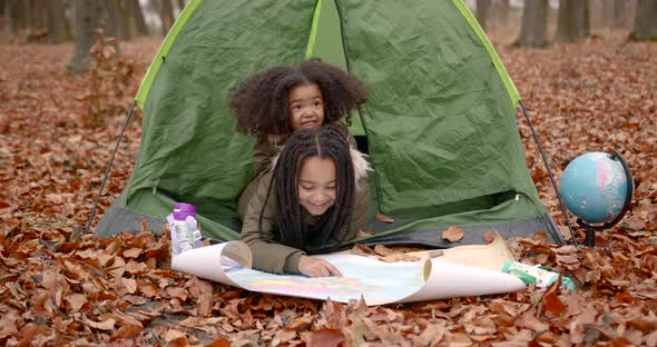 Black Girls Looking at Map in the Autumn Forest