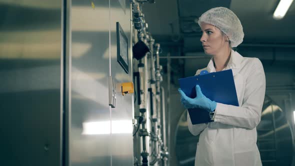 Plant Mechanism and a Lady Worker Recording Its Info