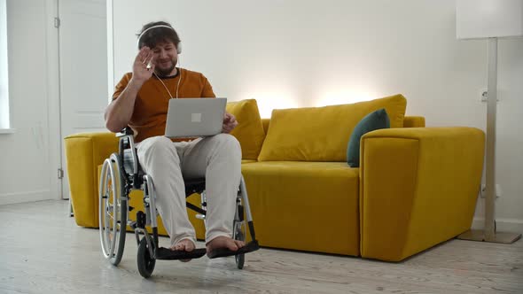 Man Freelancer Sitting on Wheelchair and Having a Videocall
