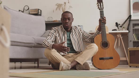 Male African Guitarist Having Video Lesson