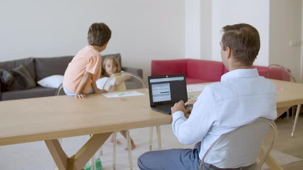 Back View of Father Using on Laptop Computer