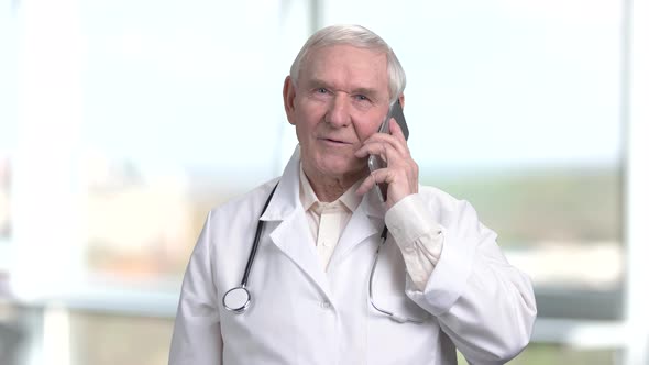 Very Old Senior Physician Talking on Phone.