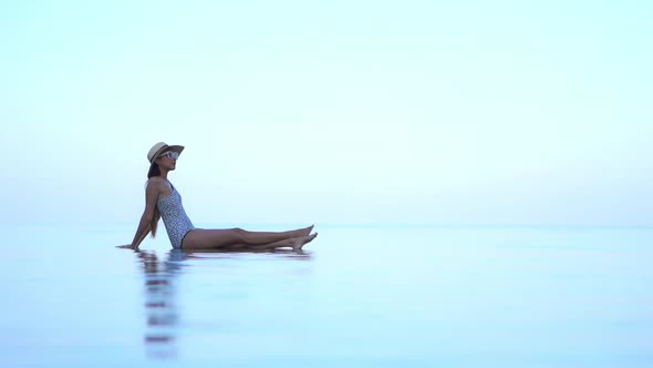 Young asian woman enjoy around outdoor swimming pool for leisure