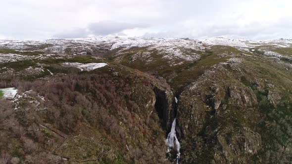 Waterfall in the Mountains with Snow