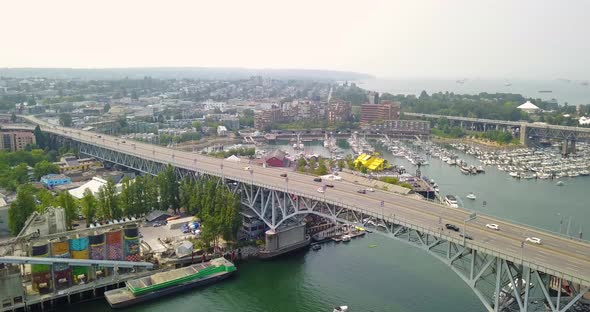 Aerial 4K Drone Zooming Out of Bridge with Traffic Cars and Reavealing Vancouver, Canada