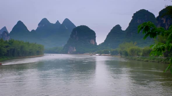 Tourist Boats on Li River with Carst Mountains in the Background