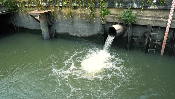 Waste water flows from pipe into a drain channel