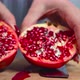 Women cuts a pomegranate with a knife - VideoHive Item for Sale