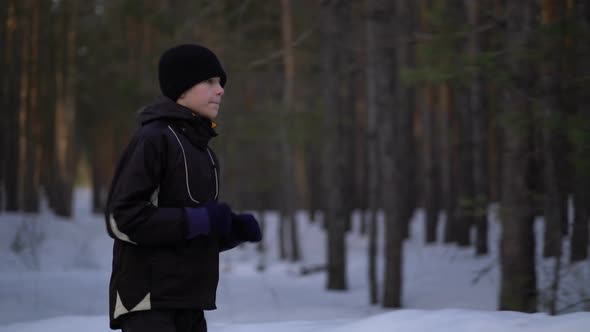 Young Male Athlete Jogging In Wintry Wood