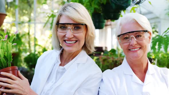 Female scientists smiling in greenhouse