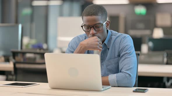 Young African American Man Thinking at Workin Office