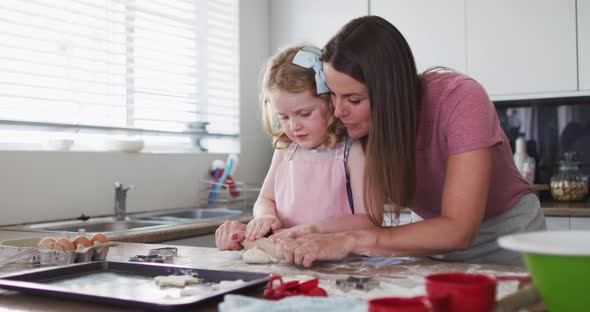 Caucasian mother and daughter having fun cooking together