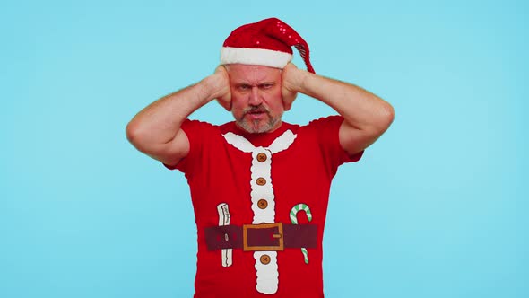 Man in Christmas Tshirt Covering Ears and Gesturing No Avoiding Advice Ignoring Unpleasant Noise