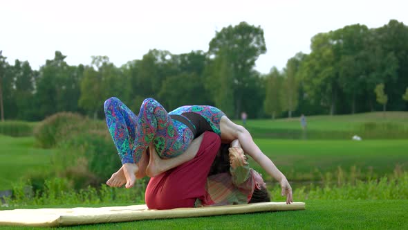 Woman Performing Yoga Exercise with Male Trainer