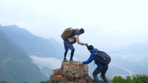 Friend Hiking Help Each Other On Mountains