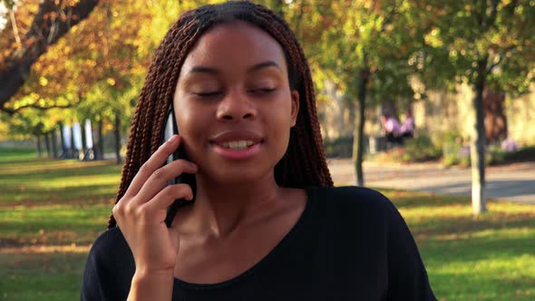 Young Beautiful Black Woman Phone in the Park in Autumn Day - Closeup