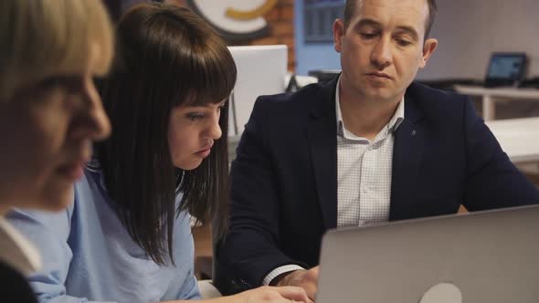 Man and Woman Using Personal Computer in Modern Office