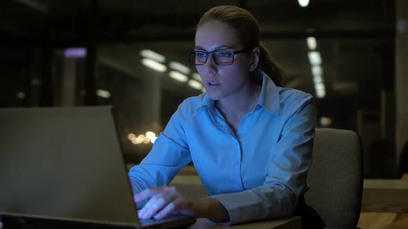 Pretty Woman Working on Laptop Late Night in Office, Conscientious Employee