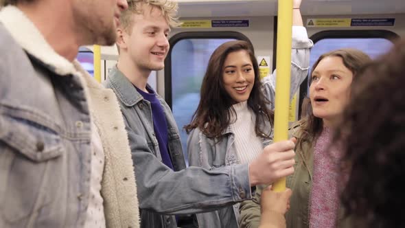 Group of young friends travelling together by tube