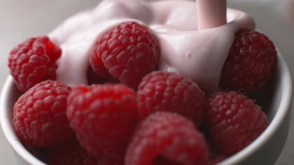 Yogurt pouring onto fresh raspberries in super slow motion, shot on Phantom Flex 4K