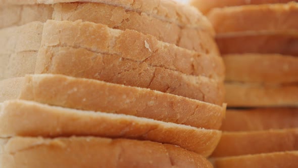 Toasting bread pieces close-up food background slow tilt 4K 2160p 30fps UHD footage - Tilting on pil