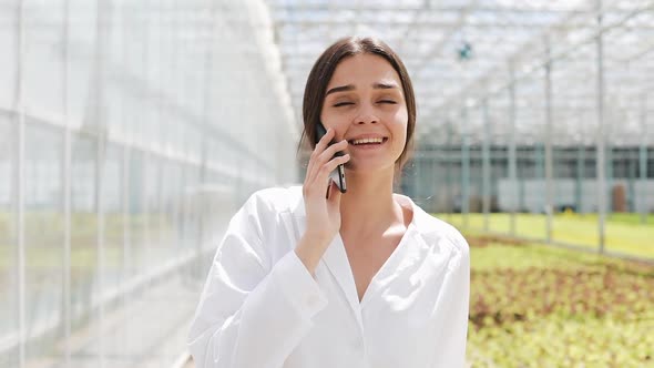 Worker Walking in a Greenhouse Using Mobile and Talking on Smartphone