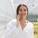 Worker Walking in a Greenhouse Using Mobile and Talking on Smartphone - VideoHive Item for Sale