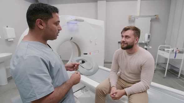 Medical Technologist Talking to Patient after CT Scan