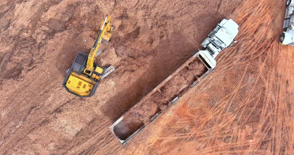 Aerial View of Excavator Loading the Tipper Truck at the Construction Site