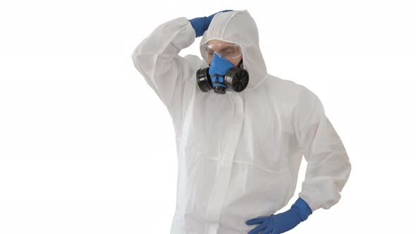 Doctor in Protective Clothes Holds His Head on White Background