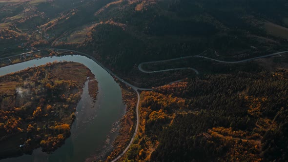 Beautiful Cinematic Aerial View of Curved Serpentine Mountain Road Yellow Fall Woods on Mountain