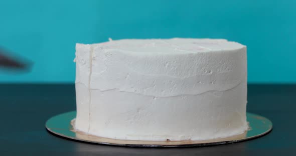 Woman Cuts a Piece of Homemade Cake with Cream and Sponge Cakes Layers