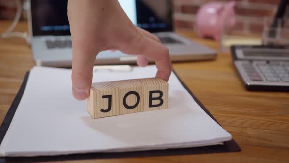 Wooden Cubes with the Words New Job are Placed on the Office Desk