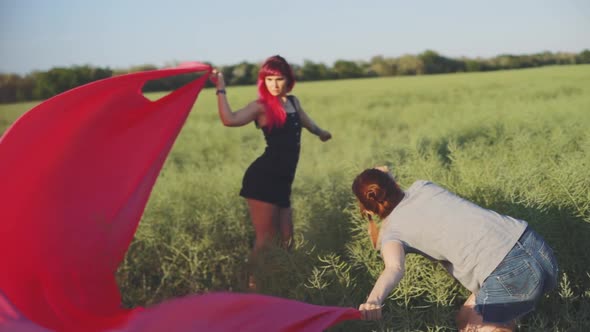 Woman Fashion Photographer Photographing on Camera a Stylish Young Woman Model with Red Hair and